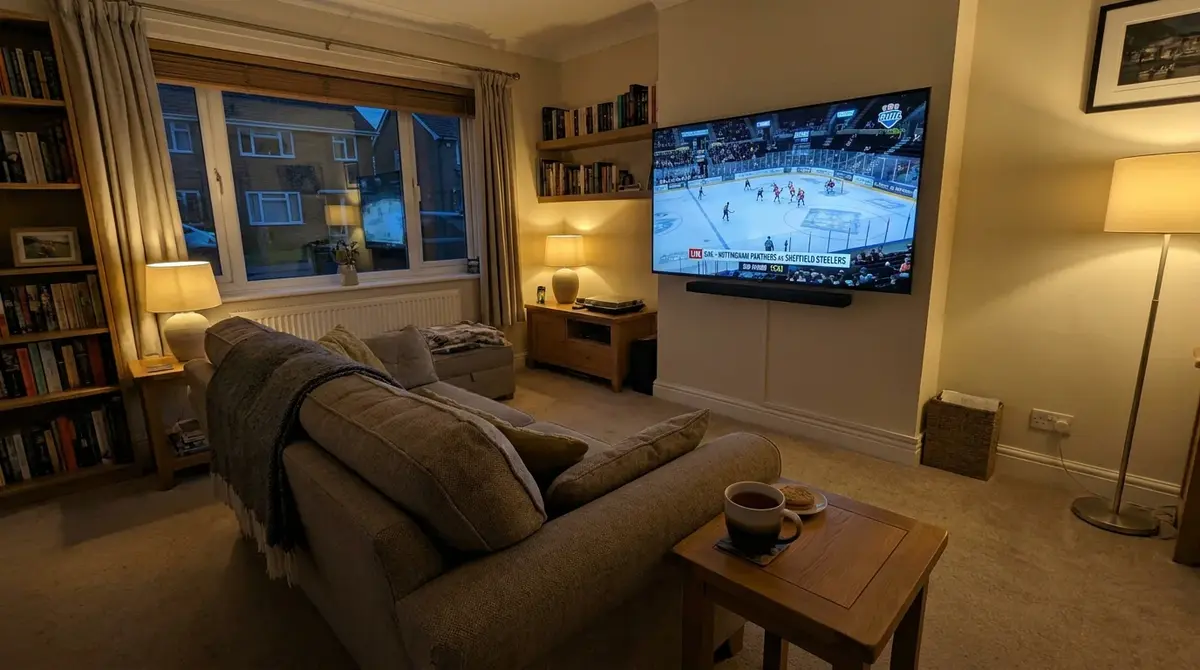UK living room television displaying a live EIHL match broadcast on a domestic sports channel