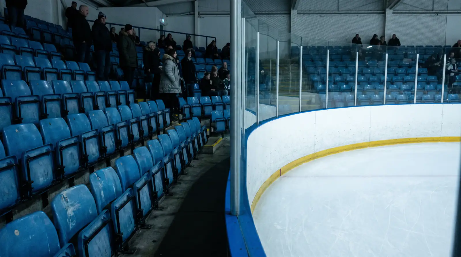 Partially empty corner section of a UK domestic ice-hockey arena