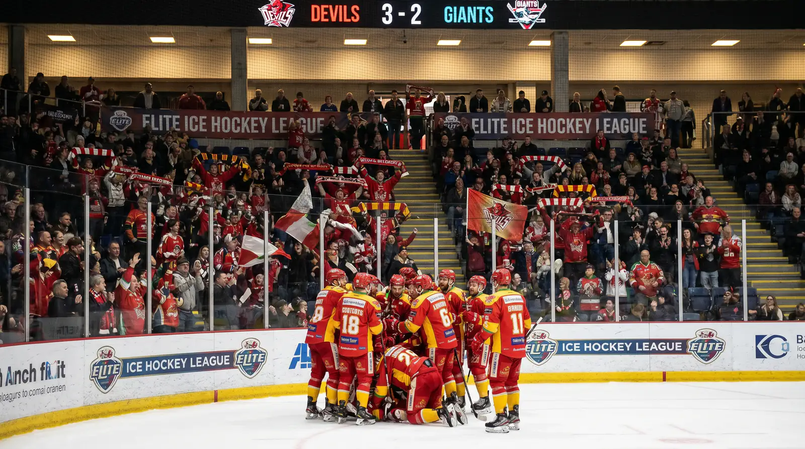 Elite Ice Hockey League goal celebration during a high-scoring British game