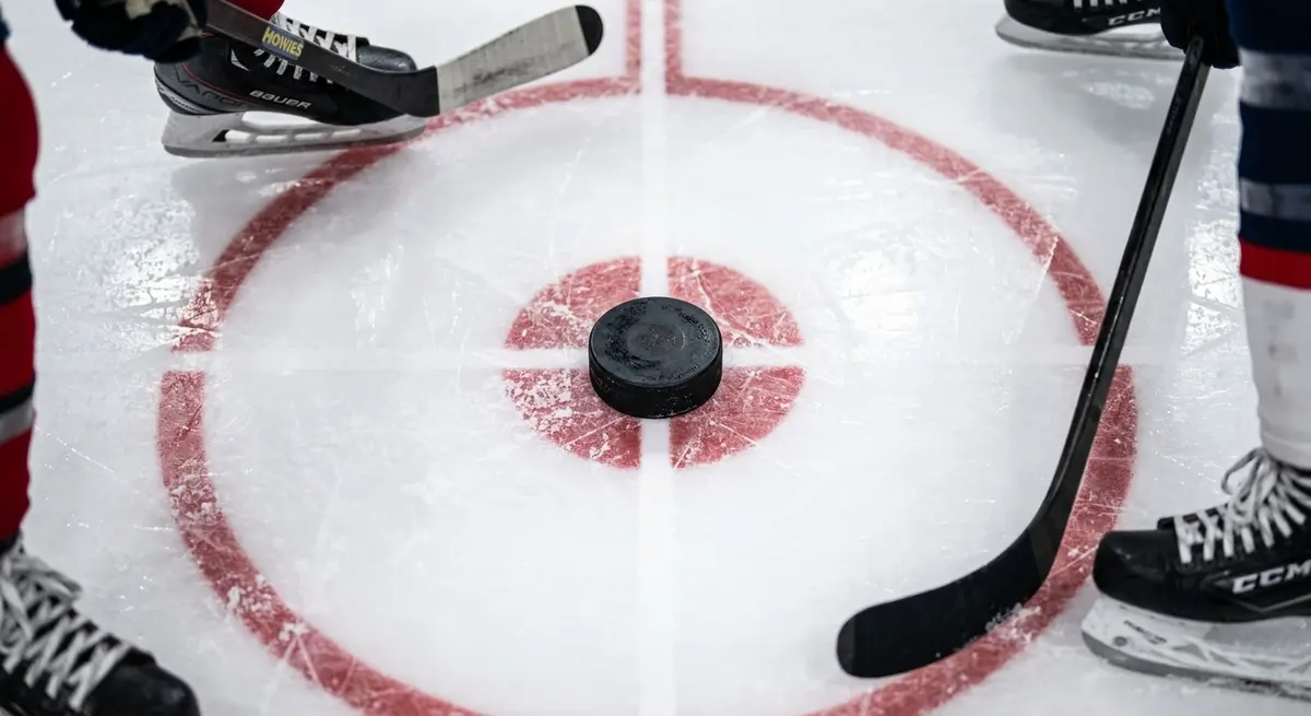 Hockey puck dropped at the centre face-off circle during an NHL game opening