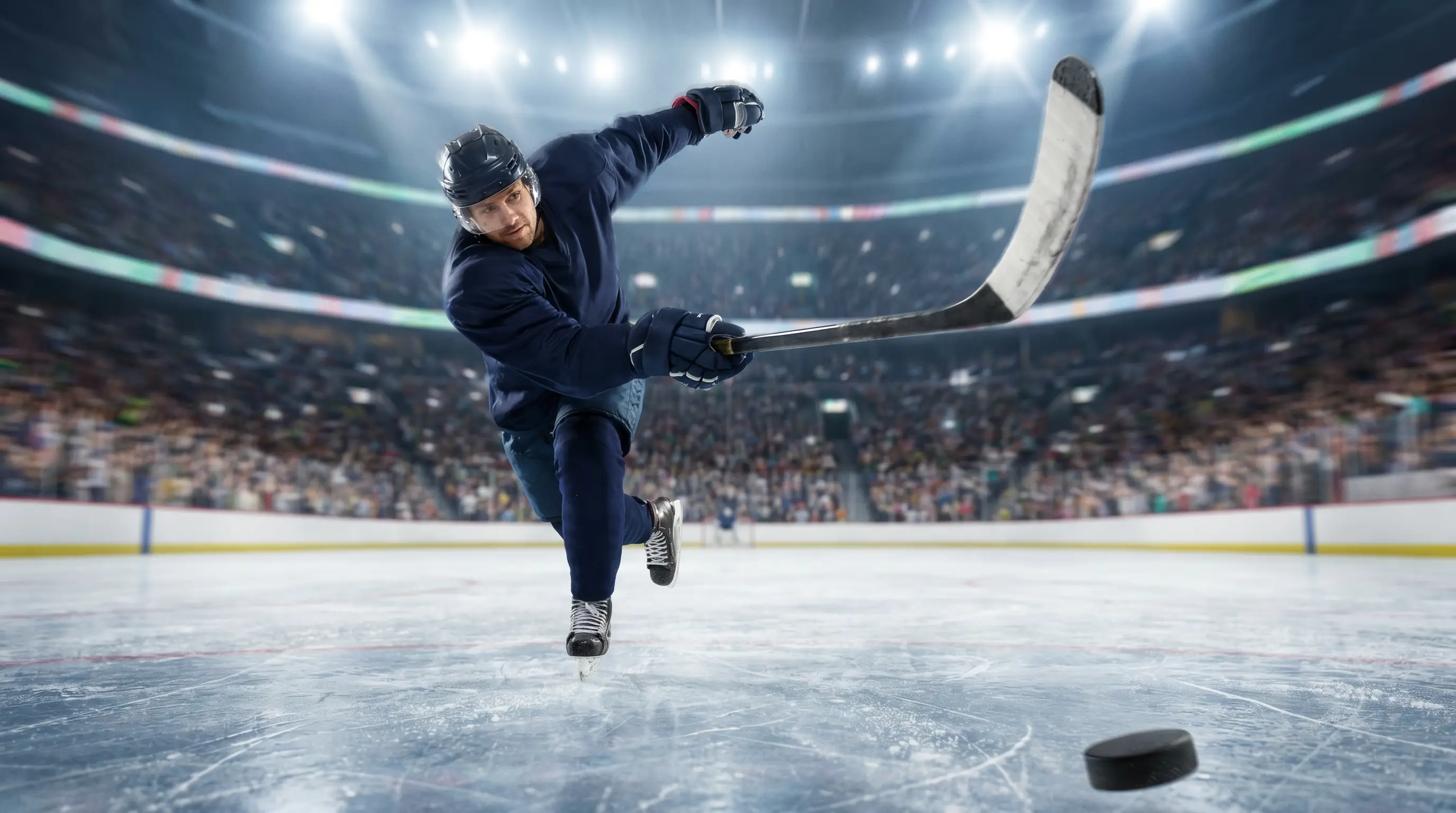NHL forward winding up to release a high-velocity slap shot