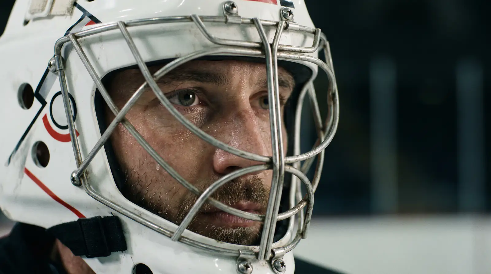 Close-up portrait of an NHL goaltender in mask and chest pads