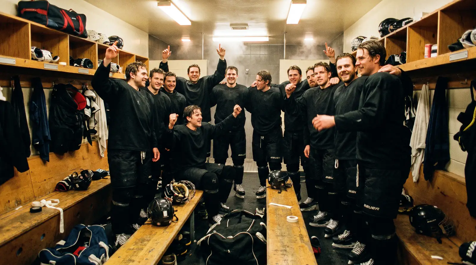 NHL players celebrating in the locker room after a playoff series win
