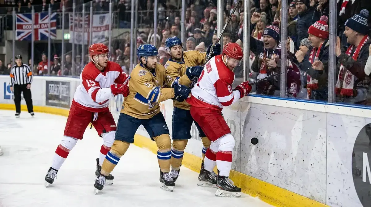 Nottingham Panthers and Sheffield Steelers players battling along the boards during a Boxing Day derby
