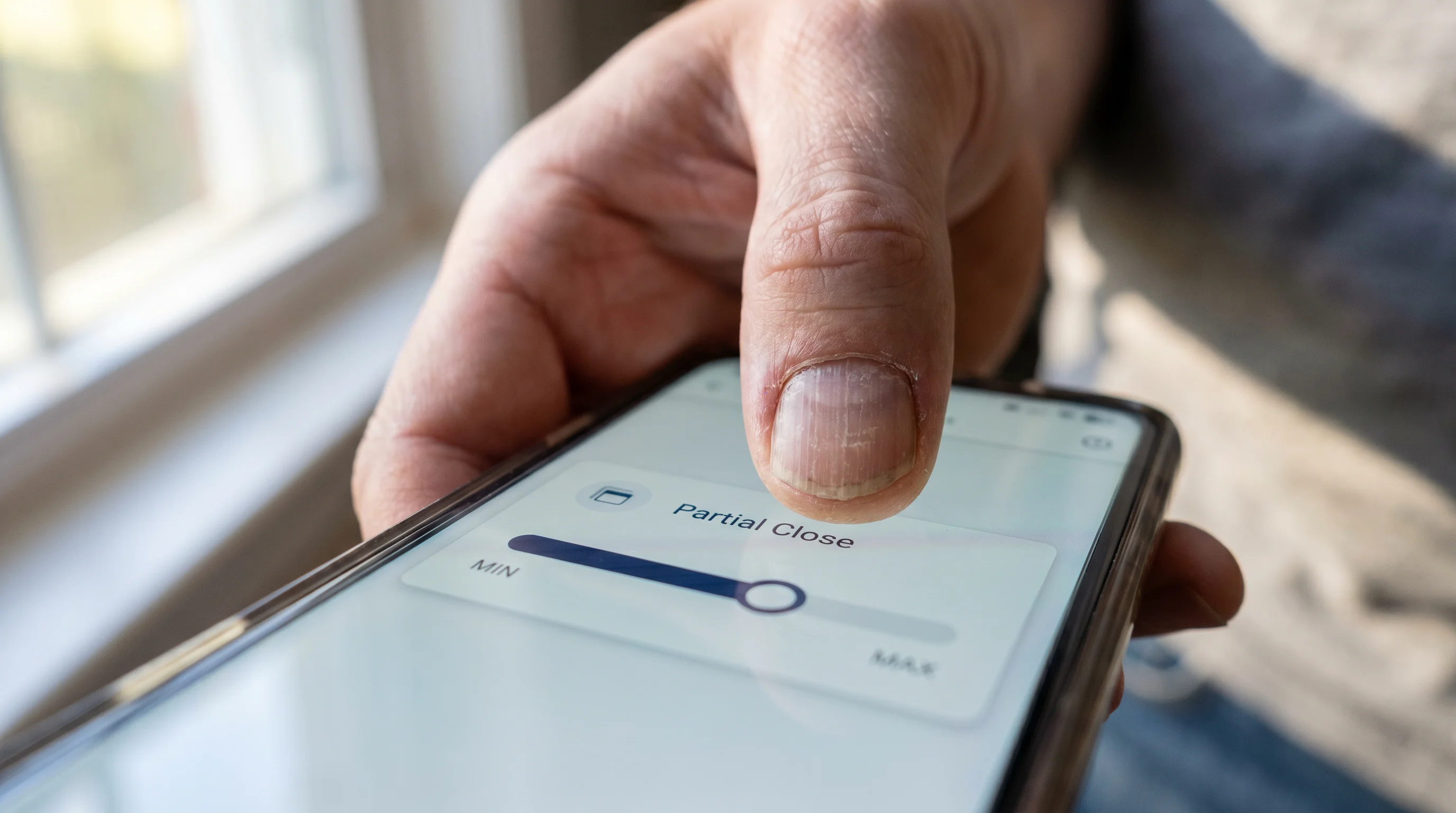 Hands tapping a slider control on a smartphone betting interface