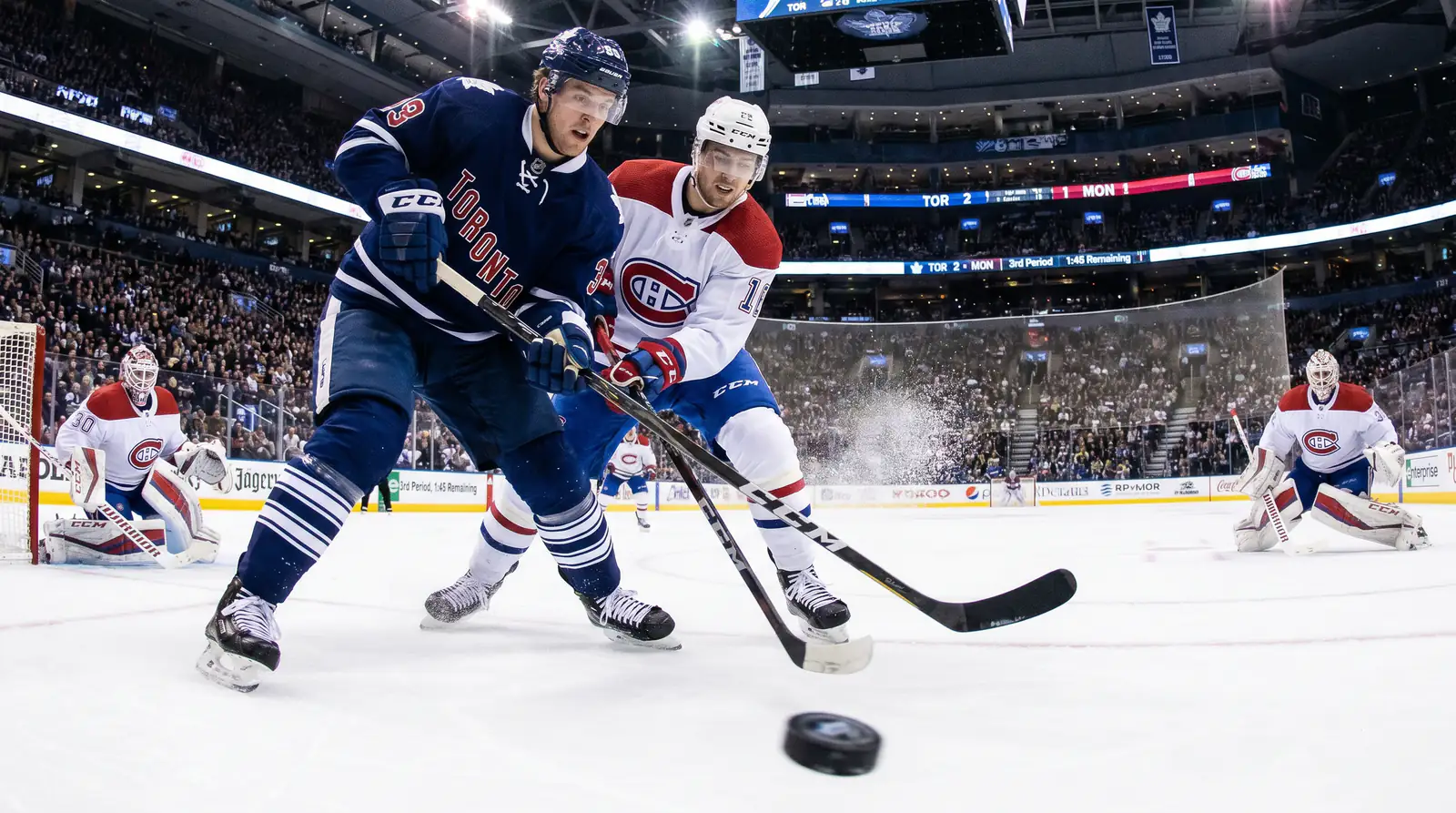 Two evenly matched NHL teams skating hard in a tight game